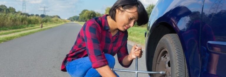 woman changing tire