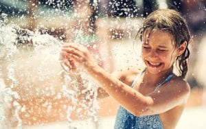 girl playing in splash pad