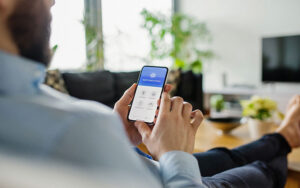 man accessing home security on phone