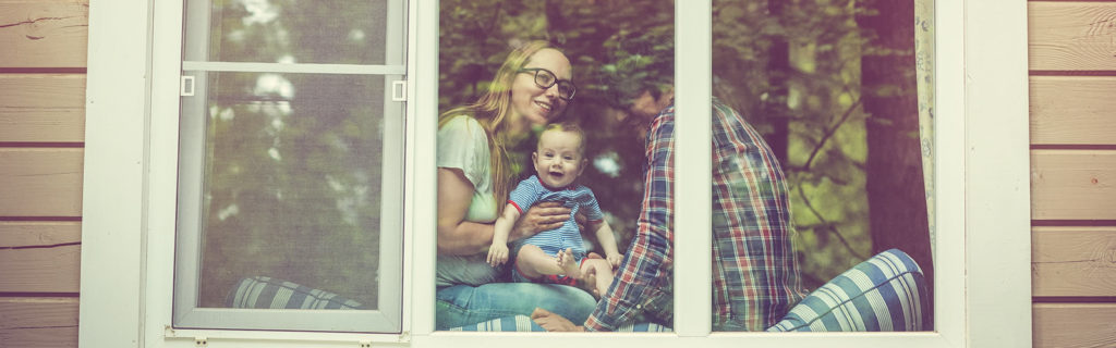 family with mom, dad, baby in window