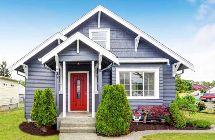 blue house with manicured lawn and red door