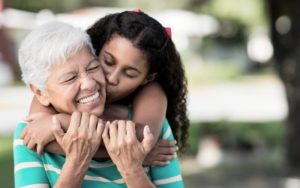 granddaughter kisses grandmother