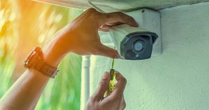 security system being installed on wall