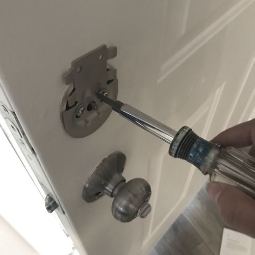 installing simplisafe lock mounting plate with screwdriver