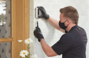 Someone installing a Vivint Doorbell